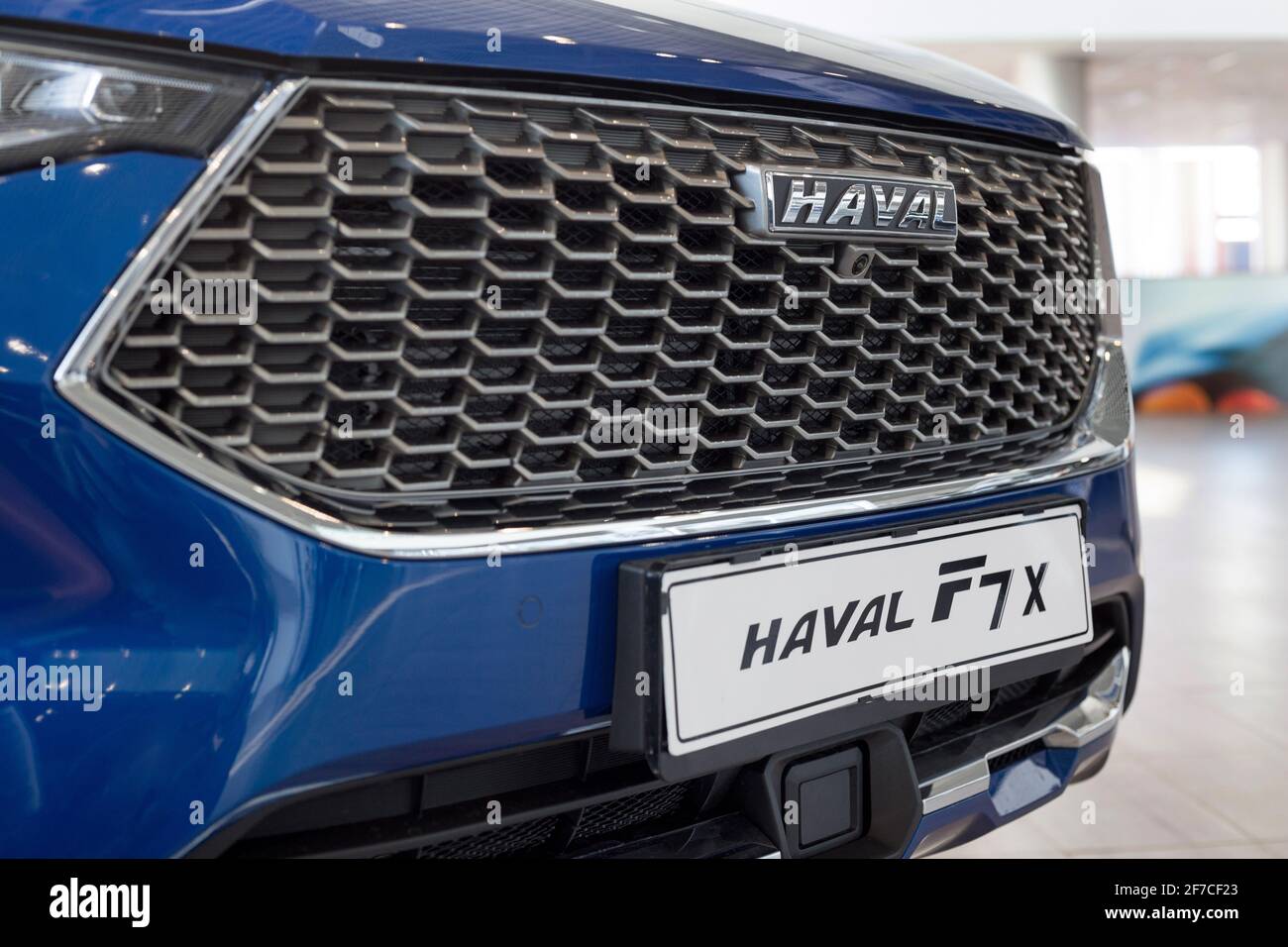 Russia, Izhevsk - February 17, 2021: Haval logo on a bumper of new car F7X at dealership showroom. Car manufacturer from China. Modern transportation. Stock Photo