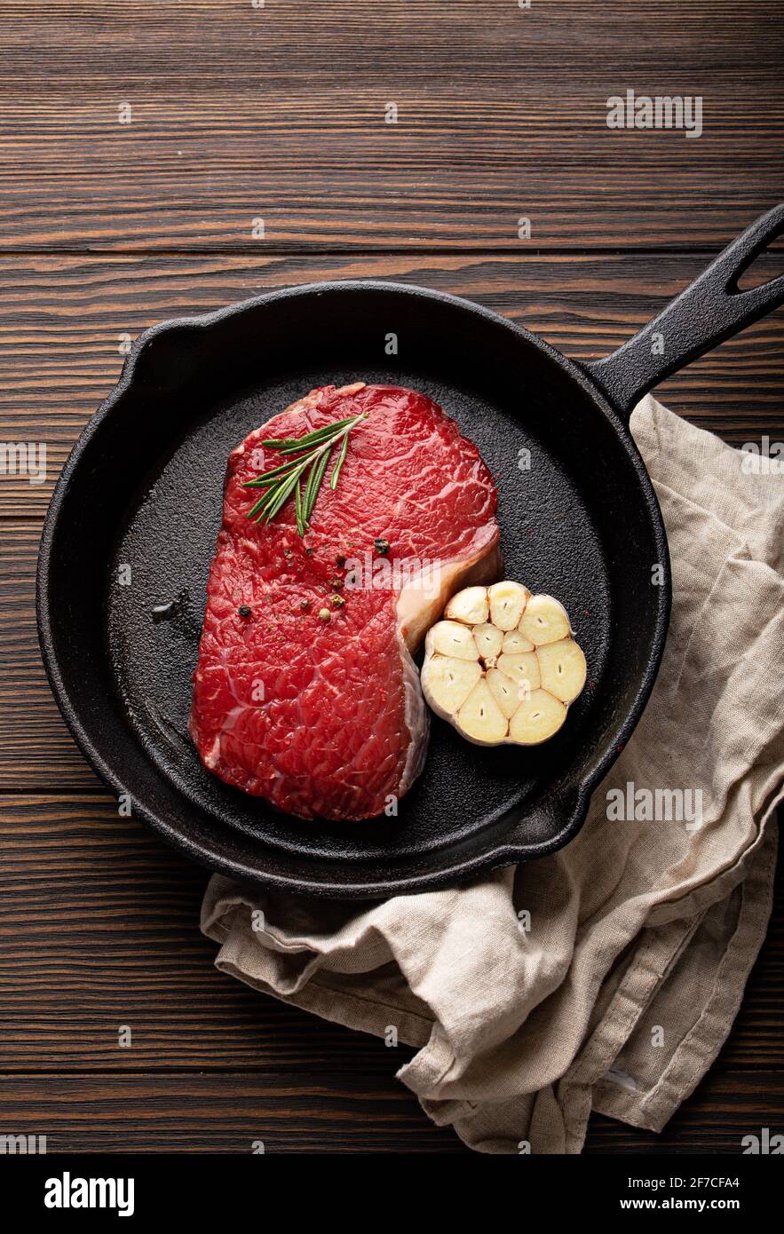 Raw beef steak on frying pan from above Stock Photo
