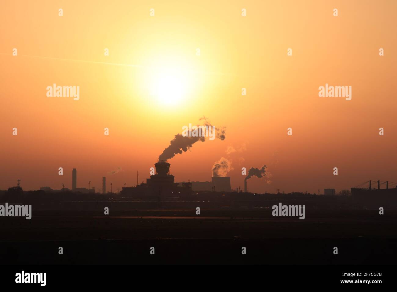 Smoke coming out of the factories at sunset Stock Photo