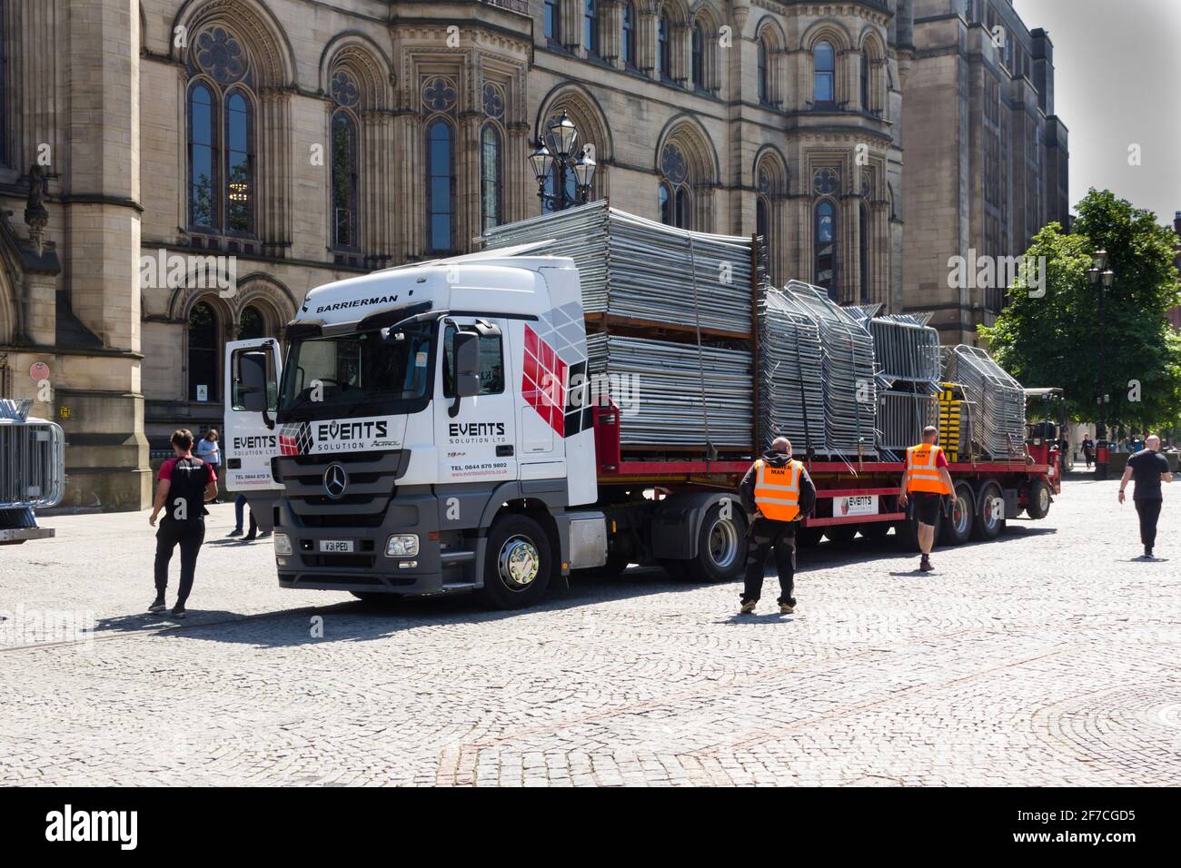 Portable crowd control barriers loaded and ready for removal from Albert Square, Manchester on an Events Solutions Ltd . articulated flat  truck. Stock Photo