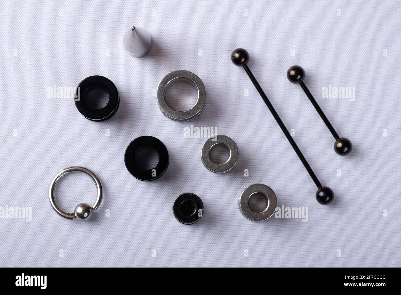 ear jewelry, ear tunnels black and silver with dilator and piercing