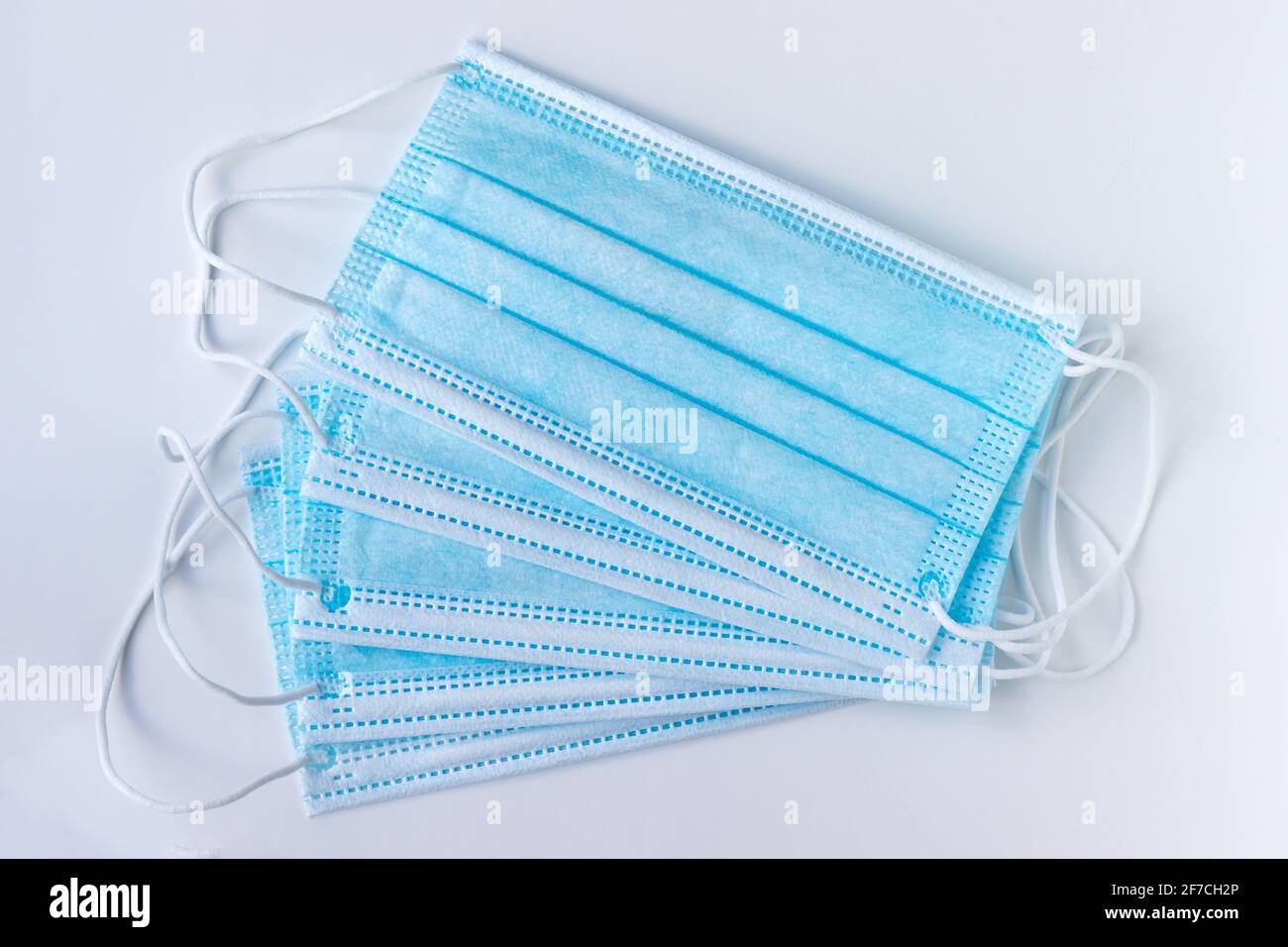 Blue protective medical face masks on a white background. Respiratory protection during quarantine, virus, coronavirus, air pollution Stock Photo