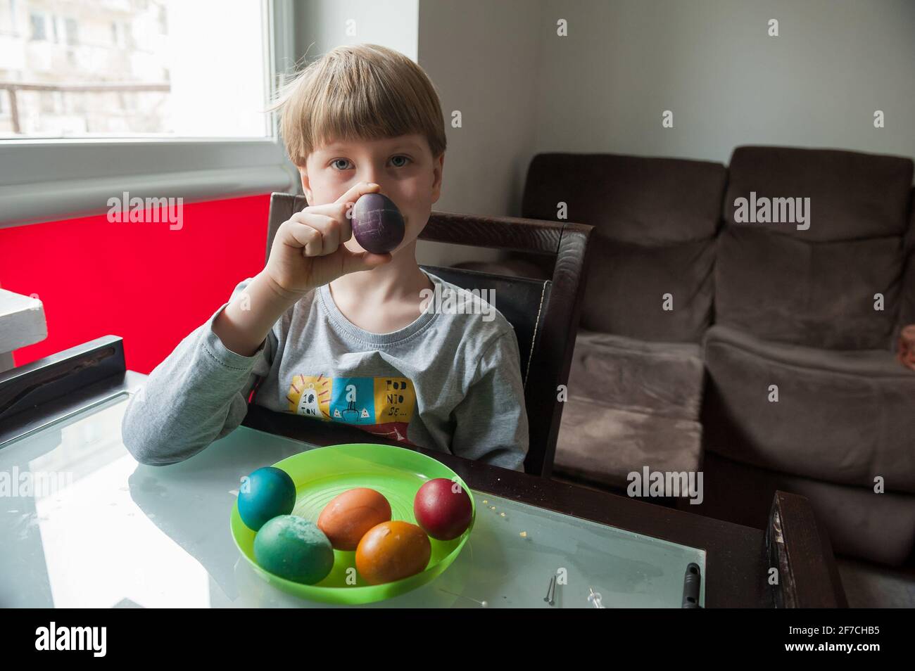 Seven year old boy decorationg traditional Polish Easter Eggs Stock