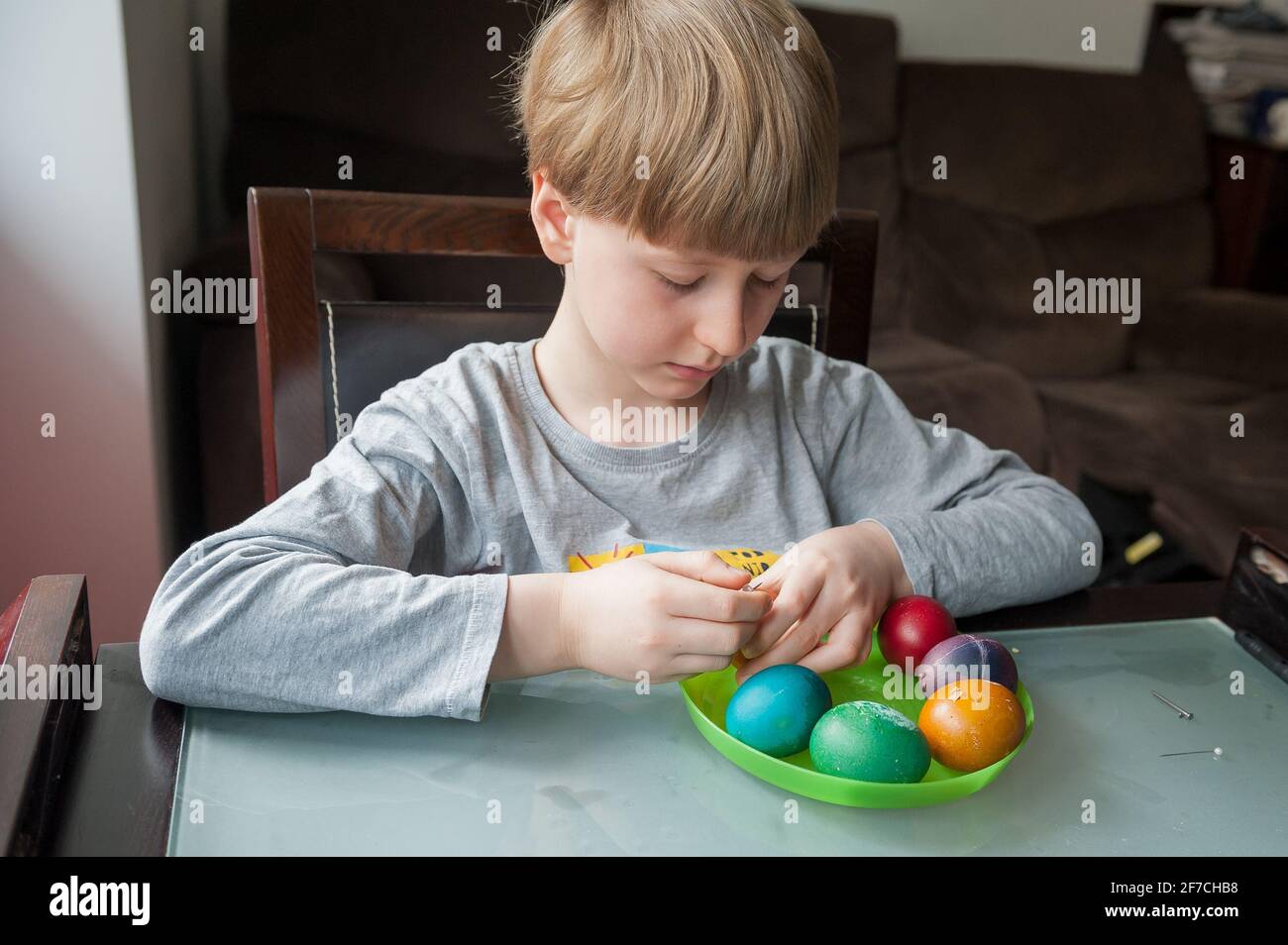 Seven year old boy decorationg traditional Polish Easter Eggs Stock