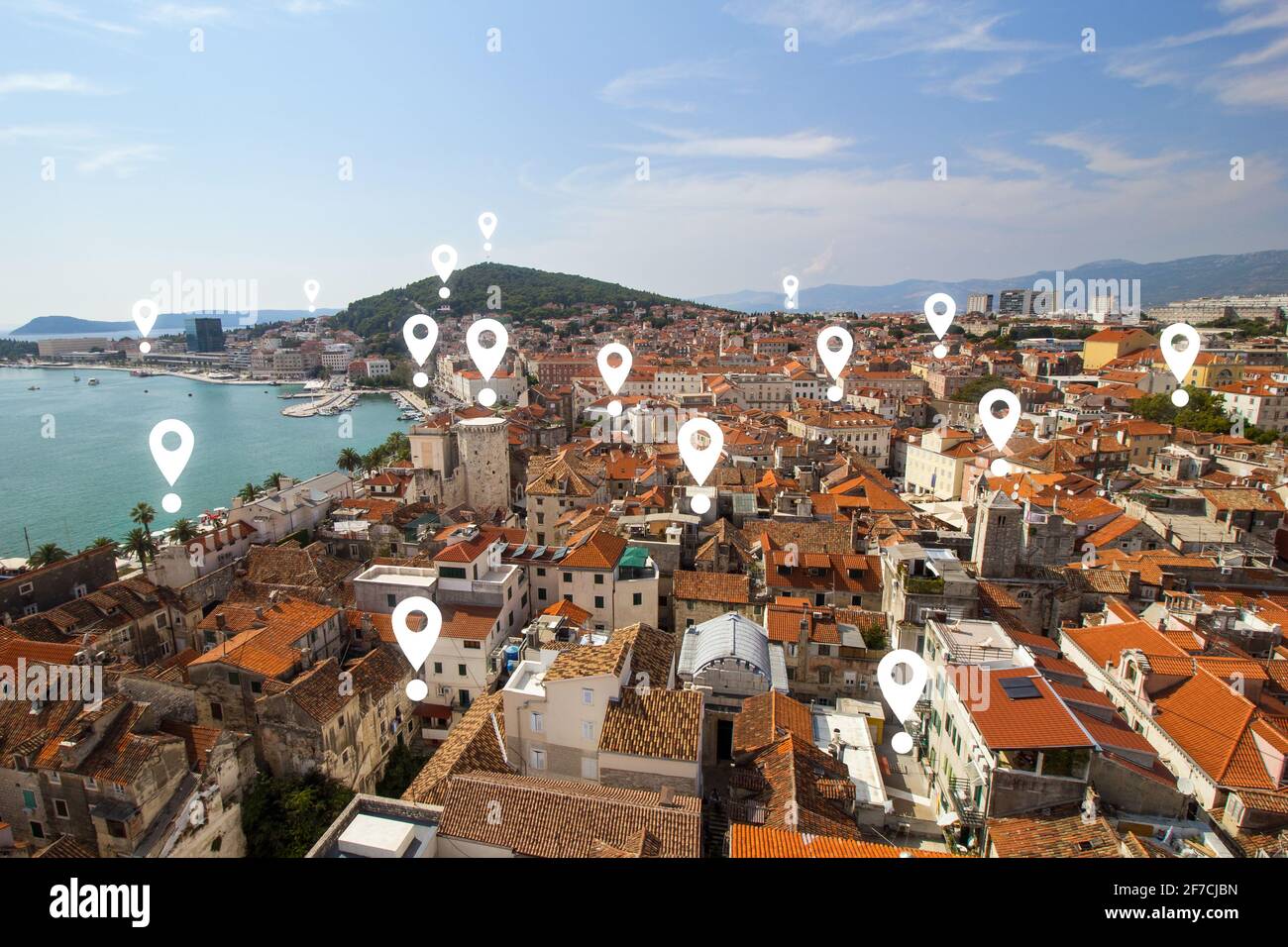 Map pin icons on Split's cityscape. View of Split's historic Diocletian's Palace, old town and Marjan hill from above in Croatia. Stock Photo