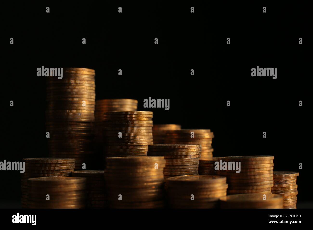 Black Coin Stack A large variety of coins on a black background. Stack of coins Stock ...