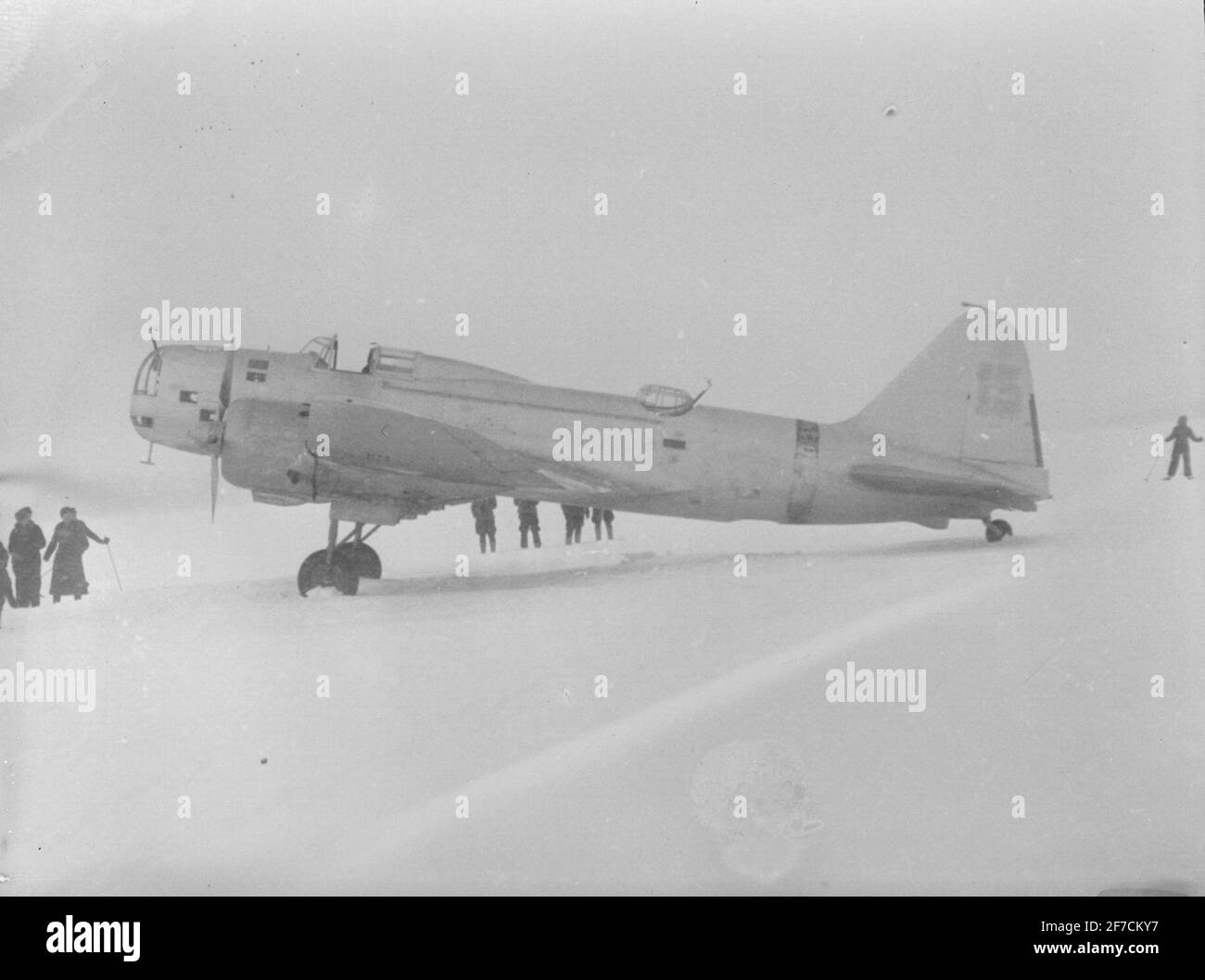 Soviet aircraft Ilehin DB-3 stands on a field during the Finnish winter war subject: Soviet aircraft Ilehin DB-3 stands in a field during the Finnish winter war, 1940. People in motion around. Picture from F 19, the Swedish NGO in Finland. Stock Photo