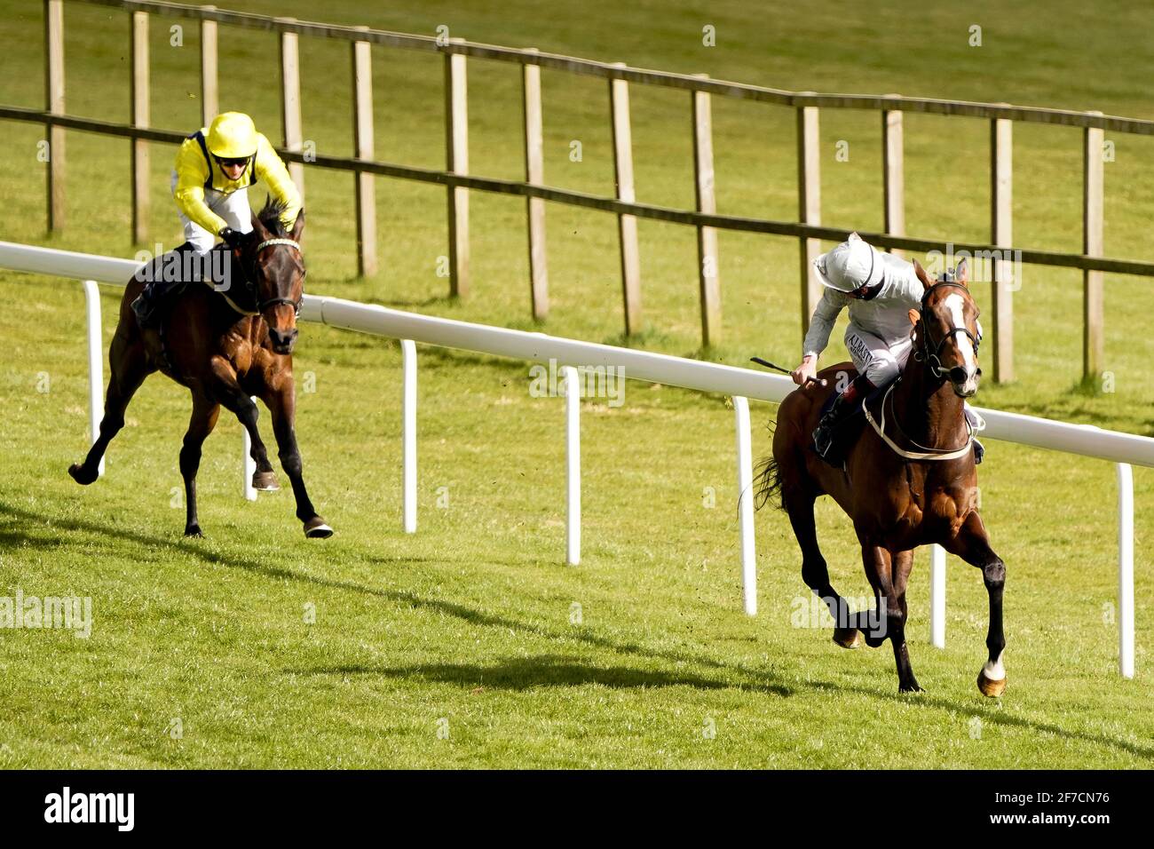 Golden Flame ridden by jockey Adam Kirby (right) on their way to winning The CB Protection Event Specialists Maiden Stakes with Going Gone ridden by jockey Charlie Bennett second at Bath Racecourse. Picture date: Tuesday April 6, 2021. Stock Photo