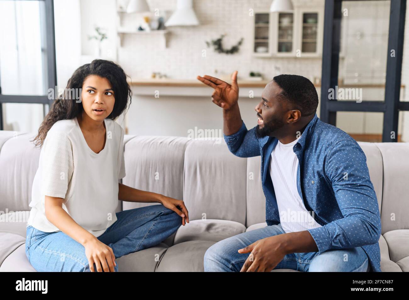 Tired frustrated african wife ignoring angry black despot husband arguing blaming upset woman of problems, jealous man shouting at sad girlfriend, family fight and controlling boyfriend, disrespect Stock Photo