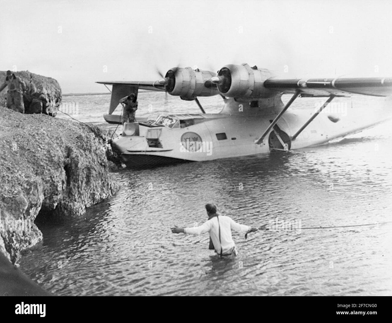 Mooring aircraft TP 47 Catalina by cliff at sea. Mooring aircraft TP 47 Catalina by cliff at sea