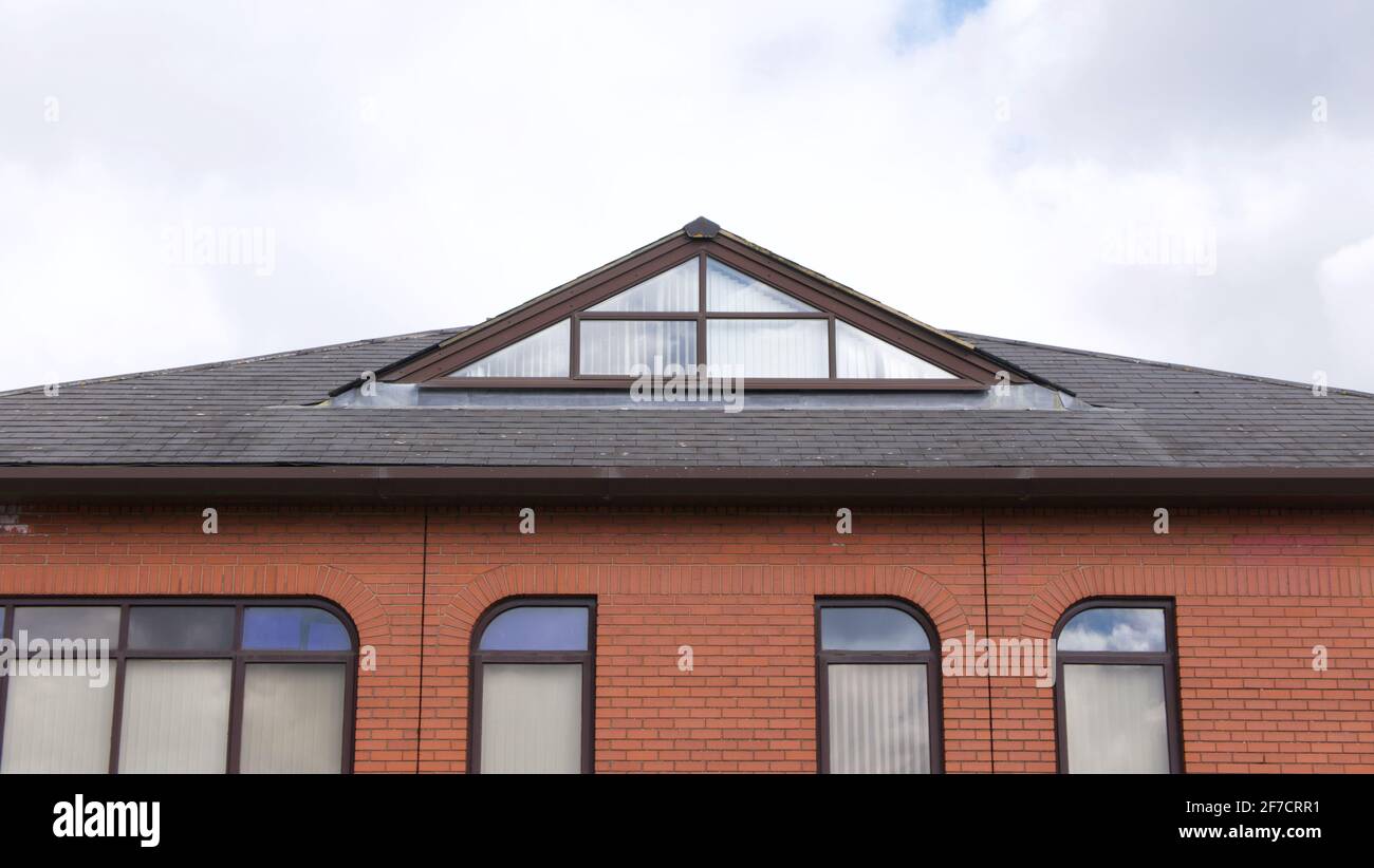 Roof and upper level of contemporary brick built corporate edifice ...