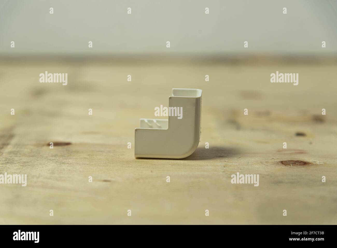 Electrical connector type elbow 90 degrees on wooden background