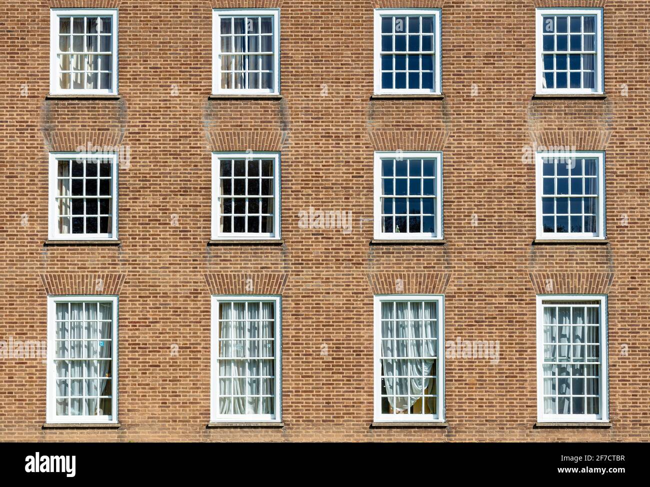 Brick wall with multiple windows in a brick wall with georgian windows multi framed glass windows rows of windows Stock Photo