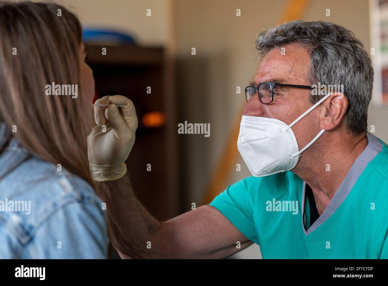 Orscholz, Germany. 06th Apr, 2021. Doctor Thomas Dehnen takes a Covid-19  test on Carolin Lackas before her training session at a gym in Orscholz,  Saarland. Saarland had started to phase out the