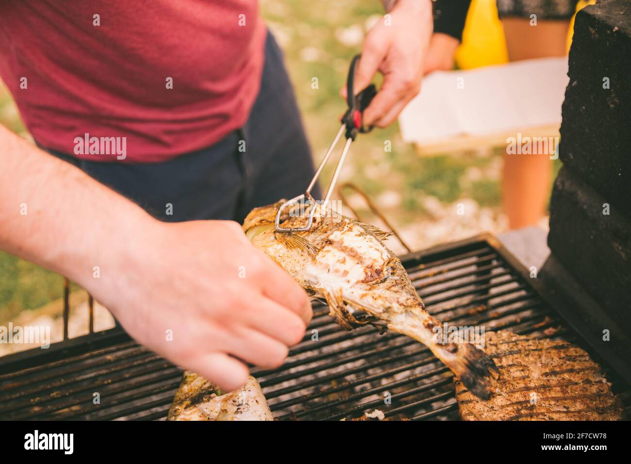 cooking fish and potatoes on grill outdoors Stock Photo - Alamy