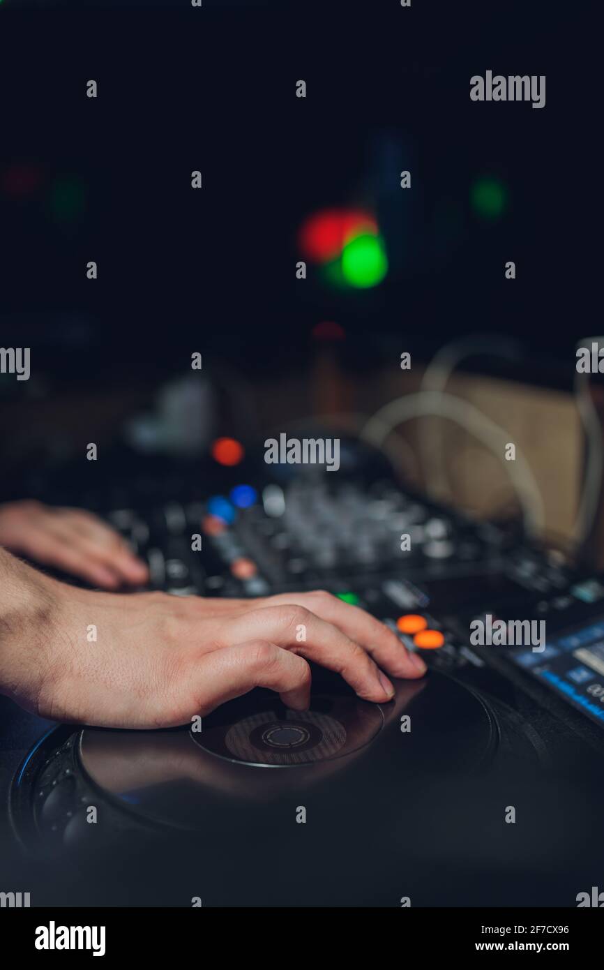 The DJ's hand on the mixer. Dj on the turntables. hand on a mixer close