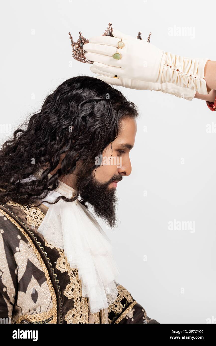 queen wearing crown on hispanic king in medieval clothing isolated on white Stock Photo