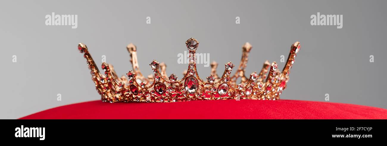 luxury royal crown on red velvet cushion isolated on grey, banner Stock ...