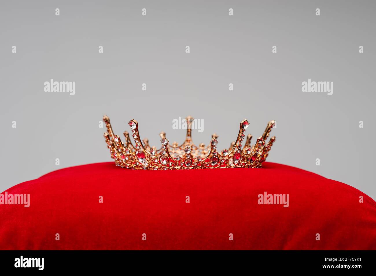 luxury royal crown on red velvet cushion isolated on grey Stock Photo ...