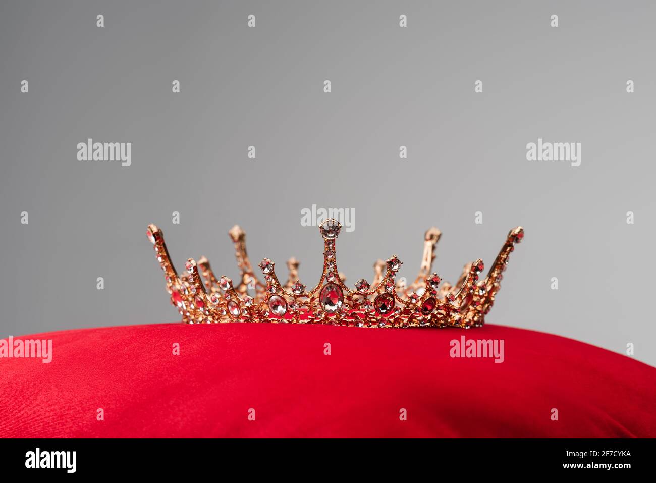 royal crown on red velvet cushion isolated on grey Stock Photo - Alamy