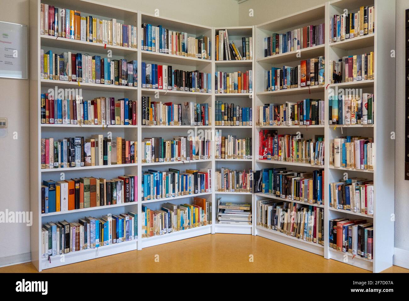 in a library there are many books on the shelves Stock Photo Alamy