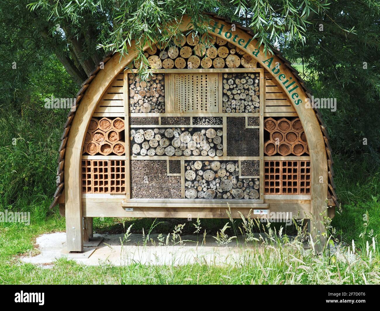 Wooden insect hotel in the garden in Bayeux, France Stock Photo