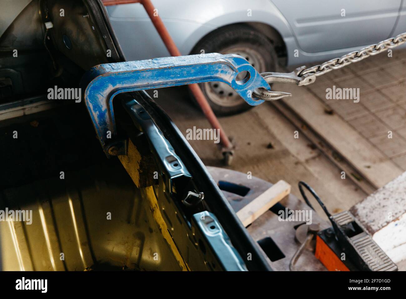 Car has dented rear bumper damaged after accident. Pulling auto body. Stock Photo