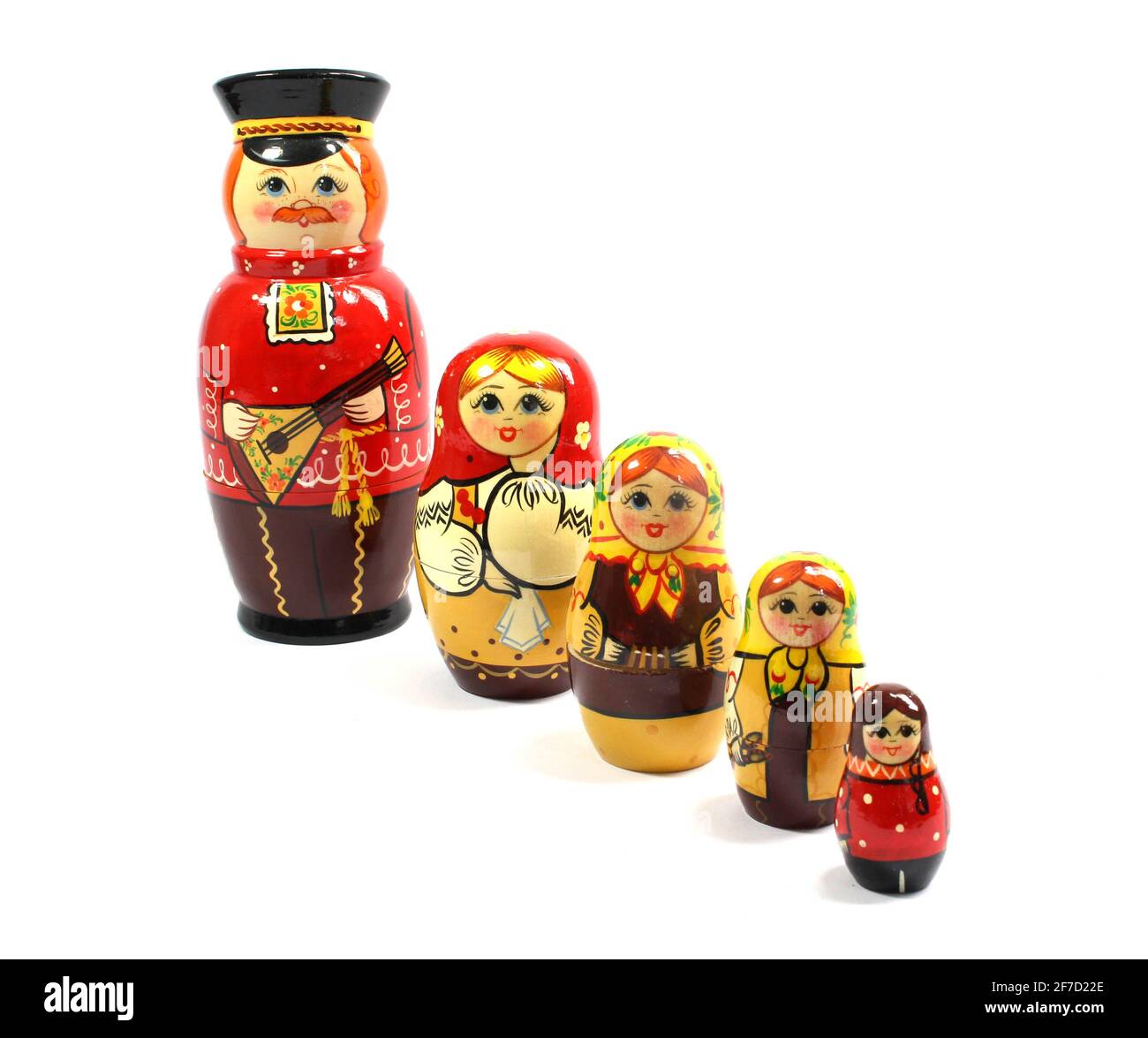 A Collection of Wooden Nesting Stacking Dolls on White Background Stock