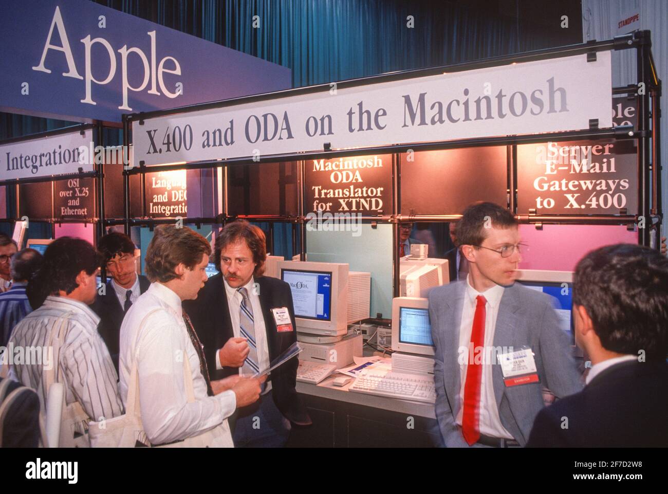 WASHINGTON, DC, USA, MAY 20, 1992 - Men talking at X.400 Apple booth during Interop 92 computer show at convention center. Stock Photo