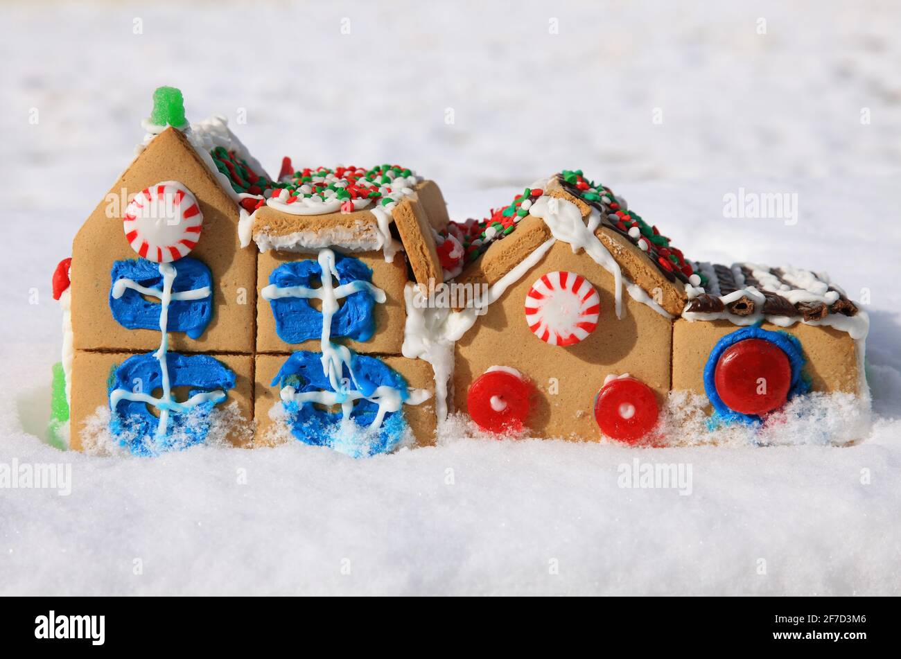 cute gingerbread house village in snow background with candy and icing Stock Photo