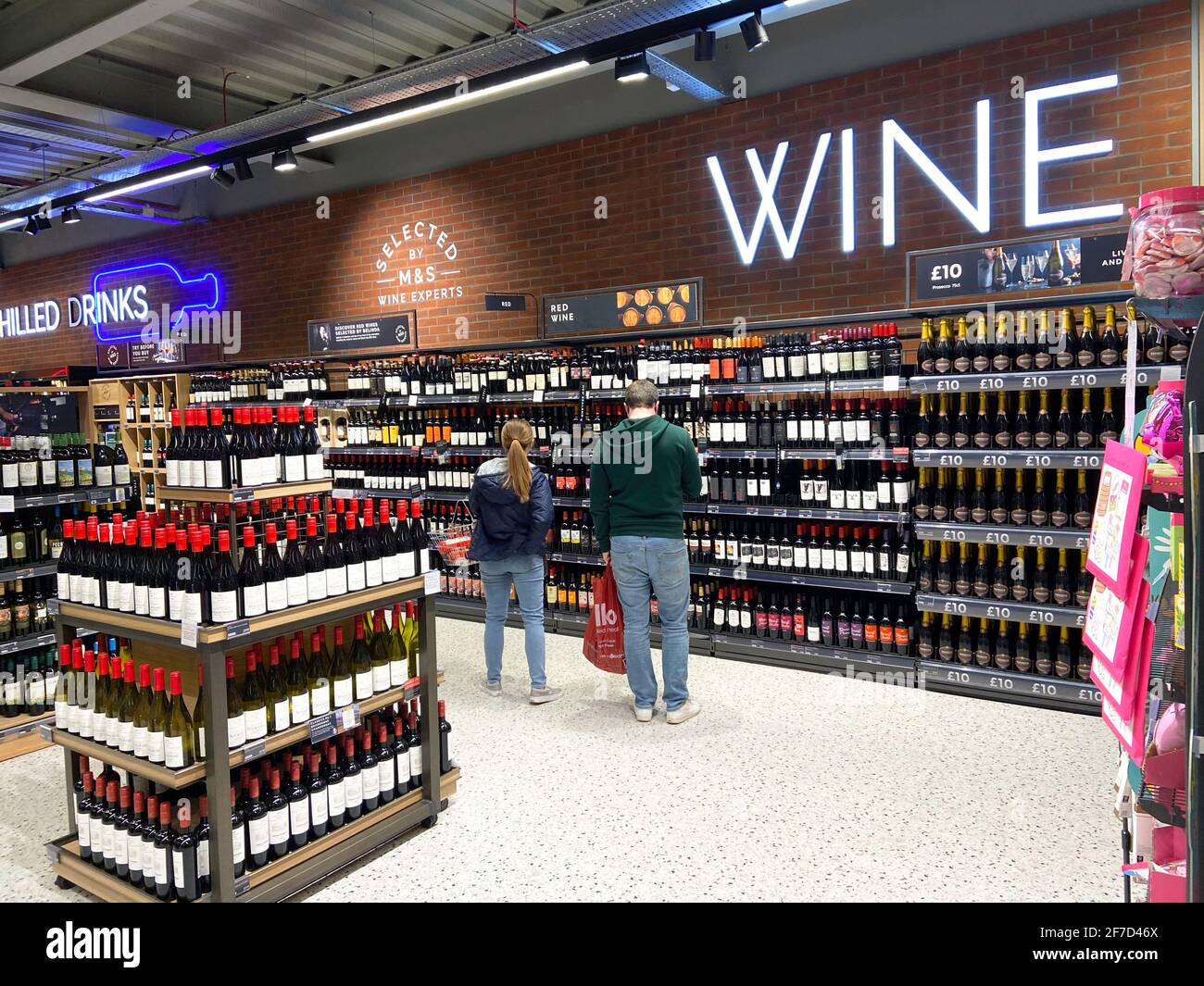 Couple in wine section inside M&S Food supermarket, Two Rivers Shopping Centre,  Staines-upon-Thames, Surrey, England, United Kingdom Stock Photo