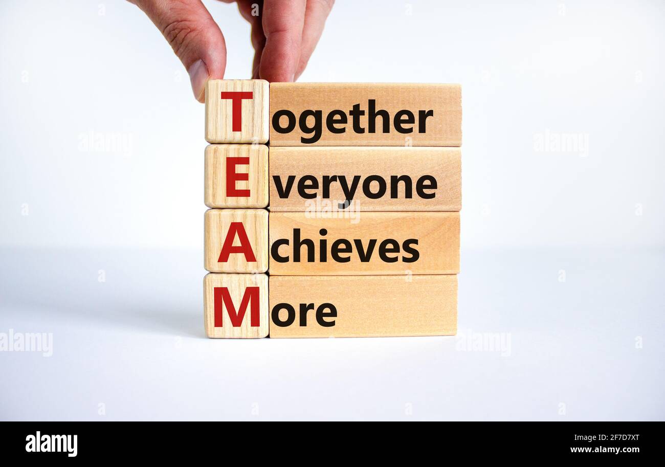 TEAM, together everyone achieves more symbol. Wooden cubes with