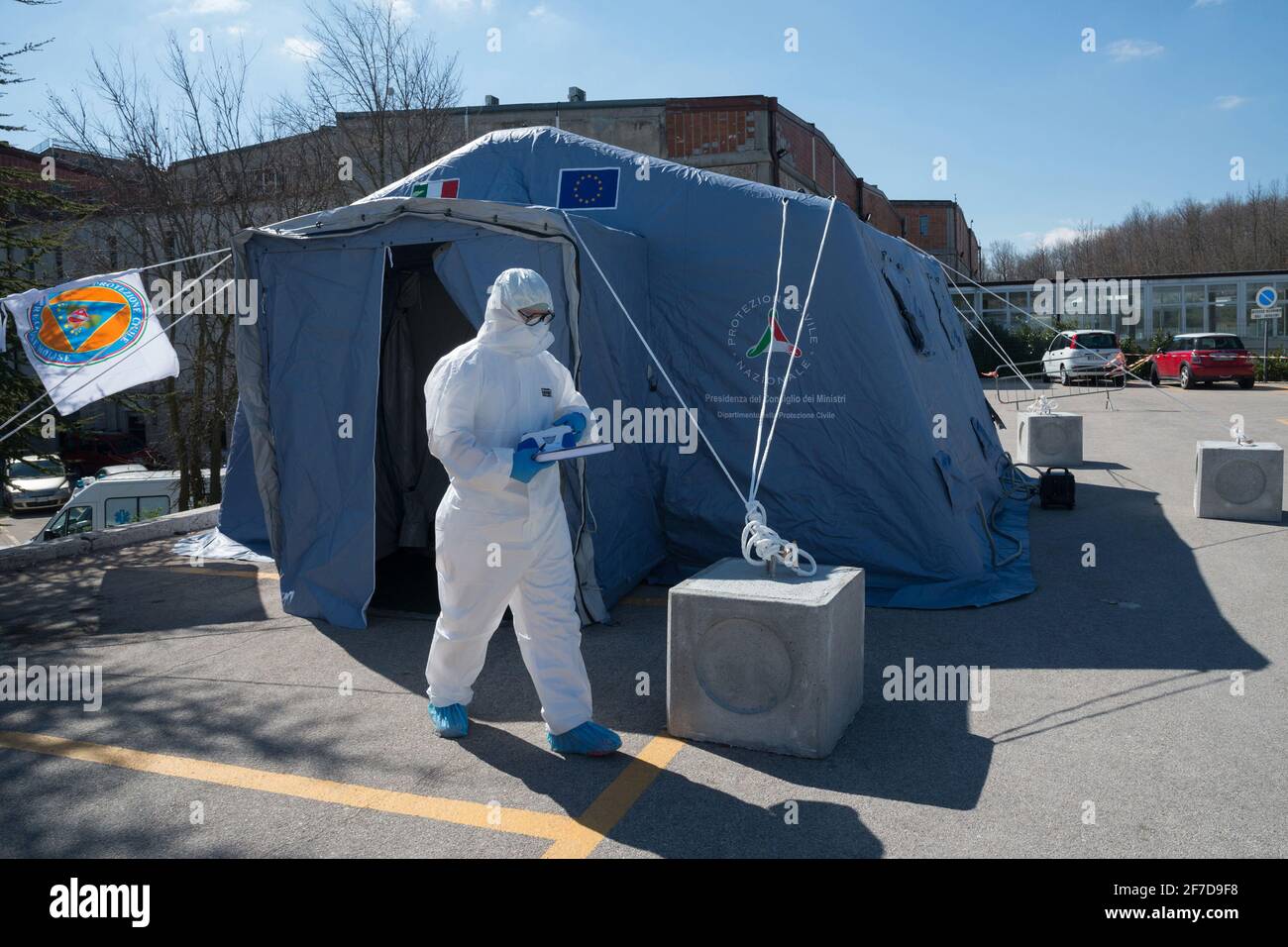 Campobasso,Molise Region,Italy:After analyzing a patient, a doctor exits the Triage tent and brings the data to be analyzed in the laboratory. Stock Photo