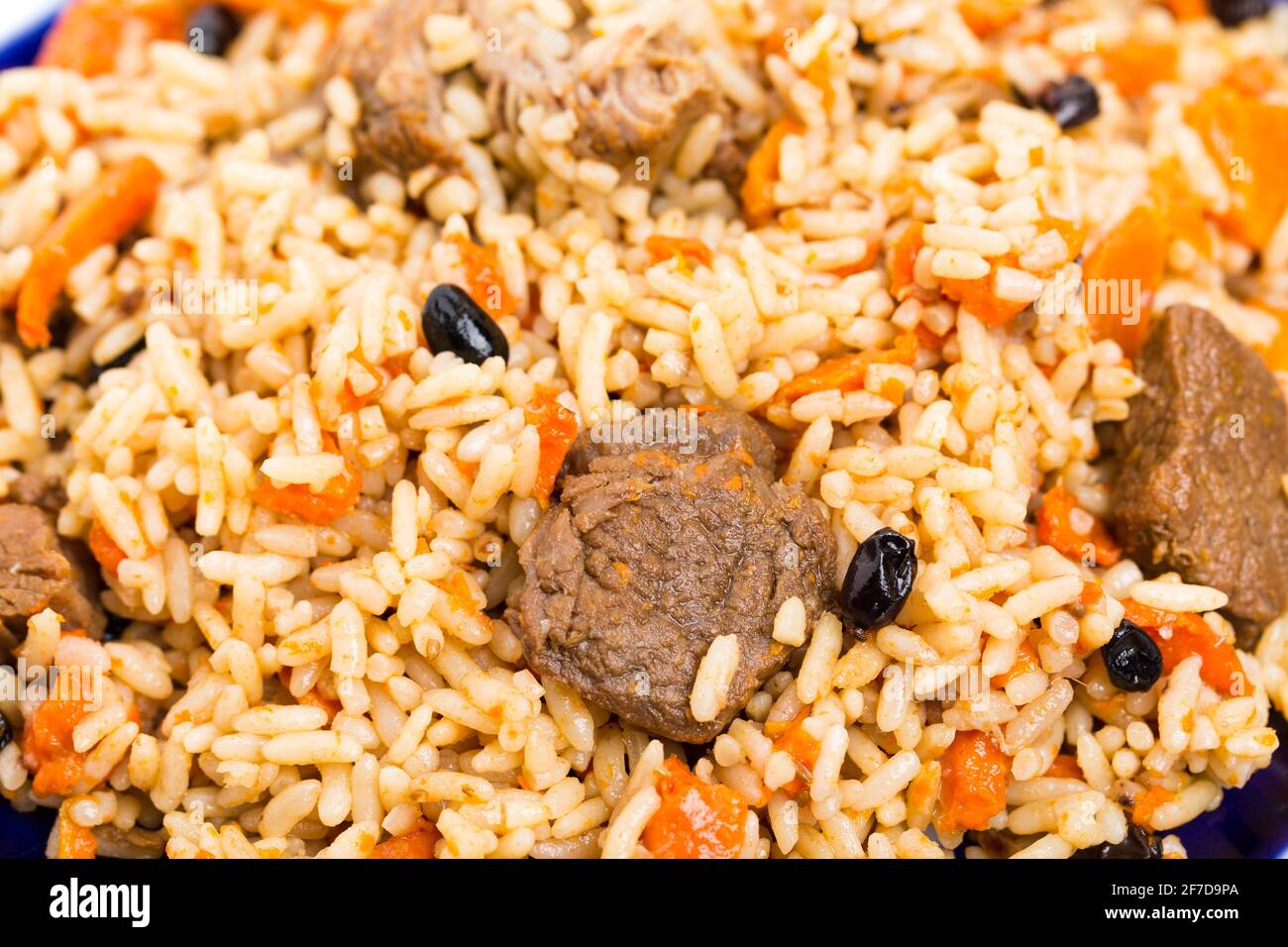 Fragrant pilaf with lamb meat and dried apricots. Macro. Photo can be