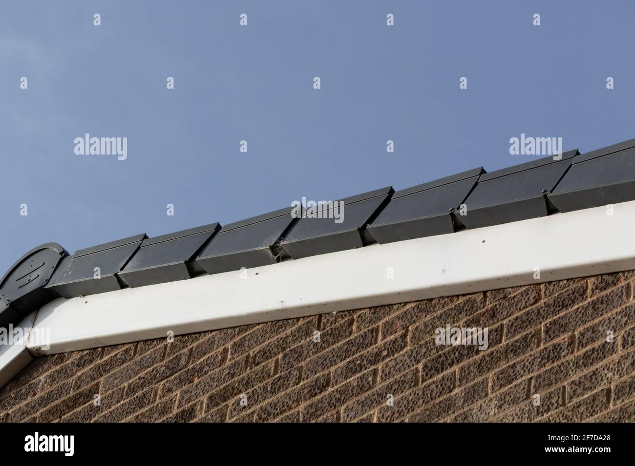 A dry verge roof system on the gable end of a house. Stock Photo