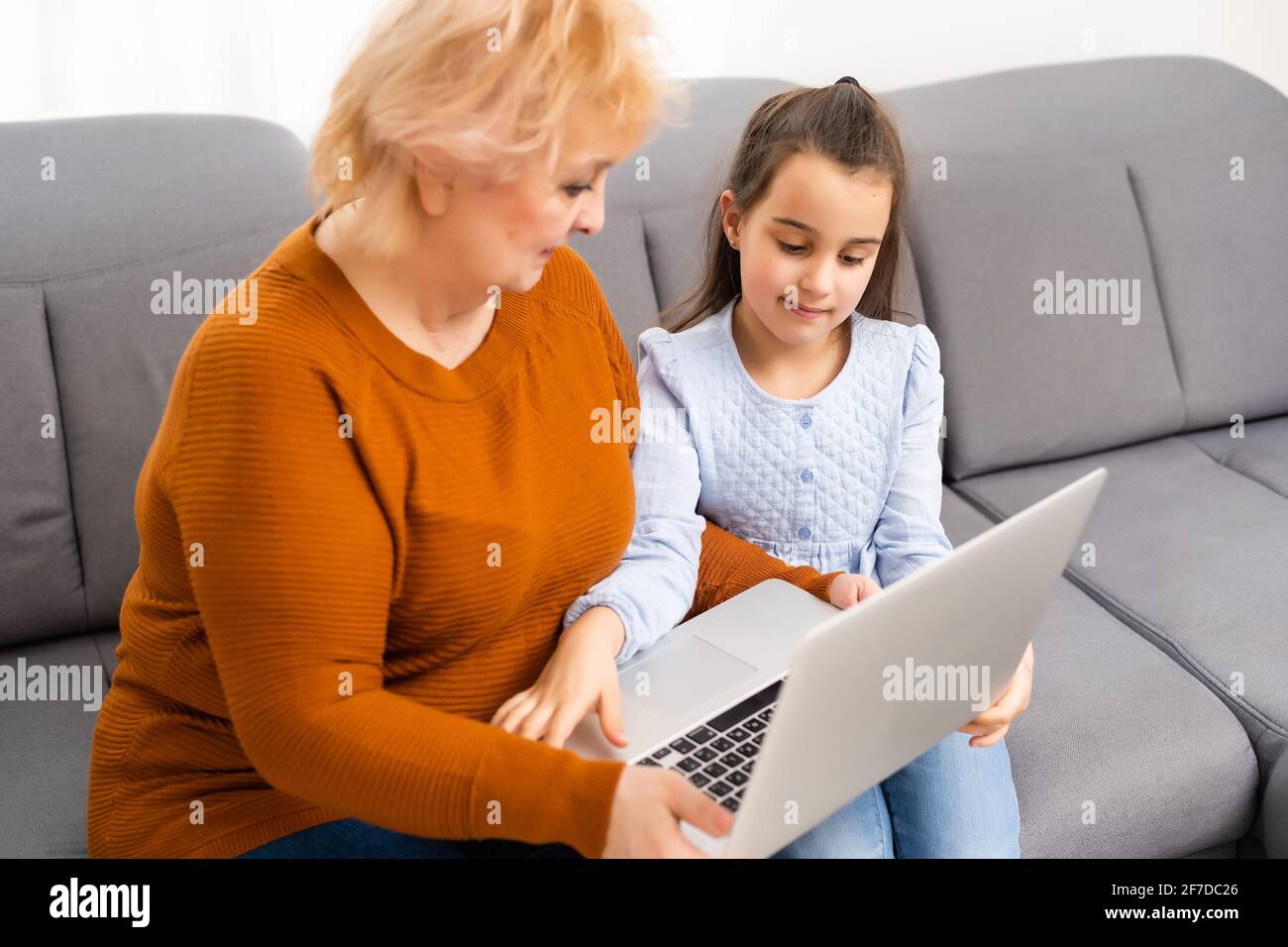 Grandmother and granddaughter with laptop Stock Photo - Alamy