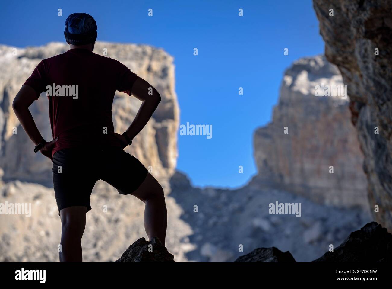 Hiker in the Casteret Cave in Ordesa and Monte Perdido National Park. The Brèche de Roland in the background (Huesca, Aragon, Spain, Pyrenees) Stock Photo
