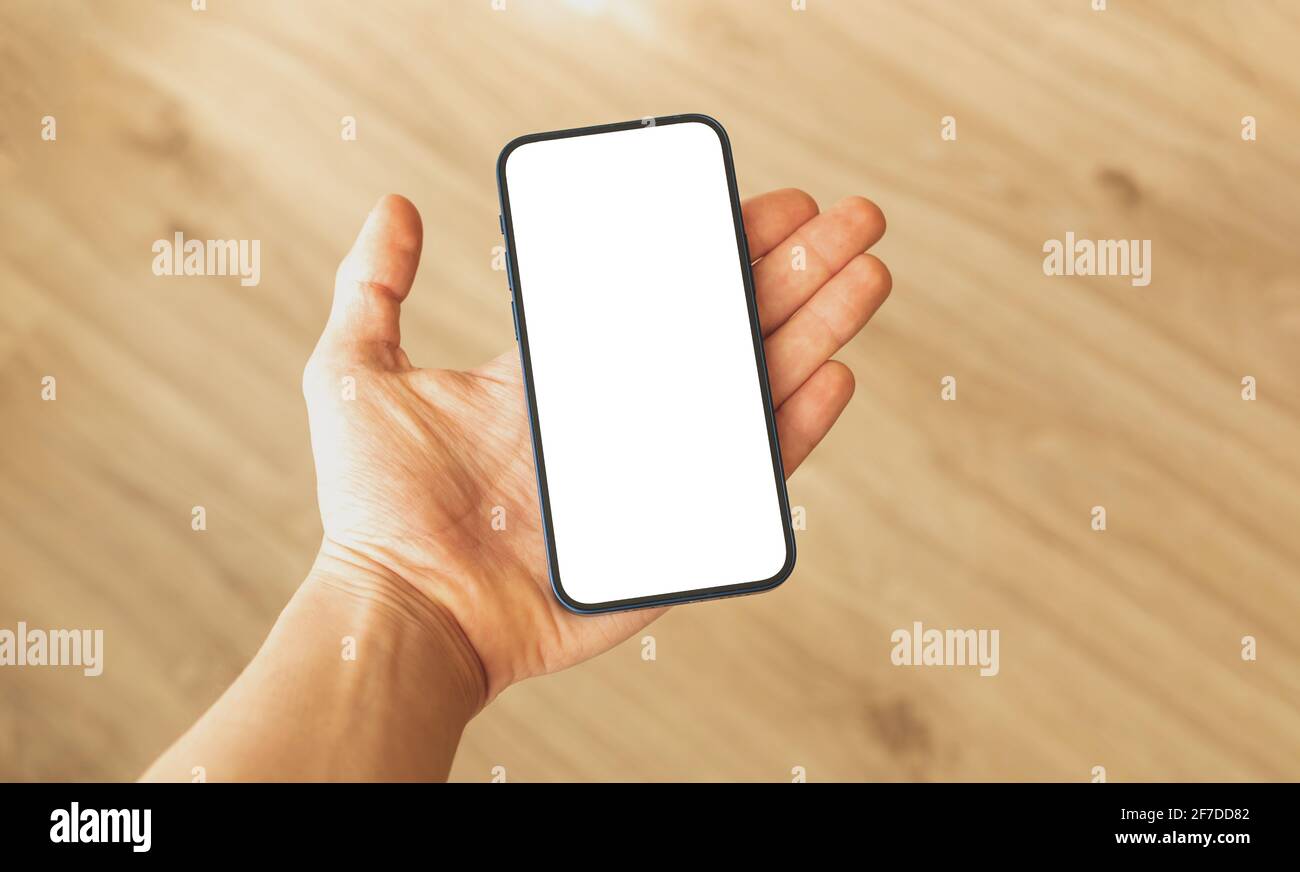Mockup frameless phone with blank white screen in man hand, copy space photo Stock Photo