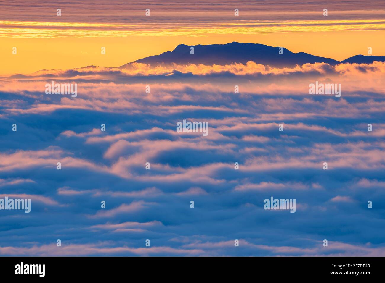 Montseny mountain in a winter sunrise over a sea of clouds seen from the Figuerassa viewpoint, (Berguedà, Catalonia, Spain, Pyrenees) Stock Photo