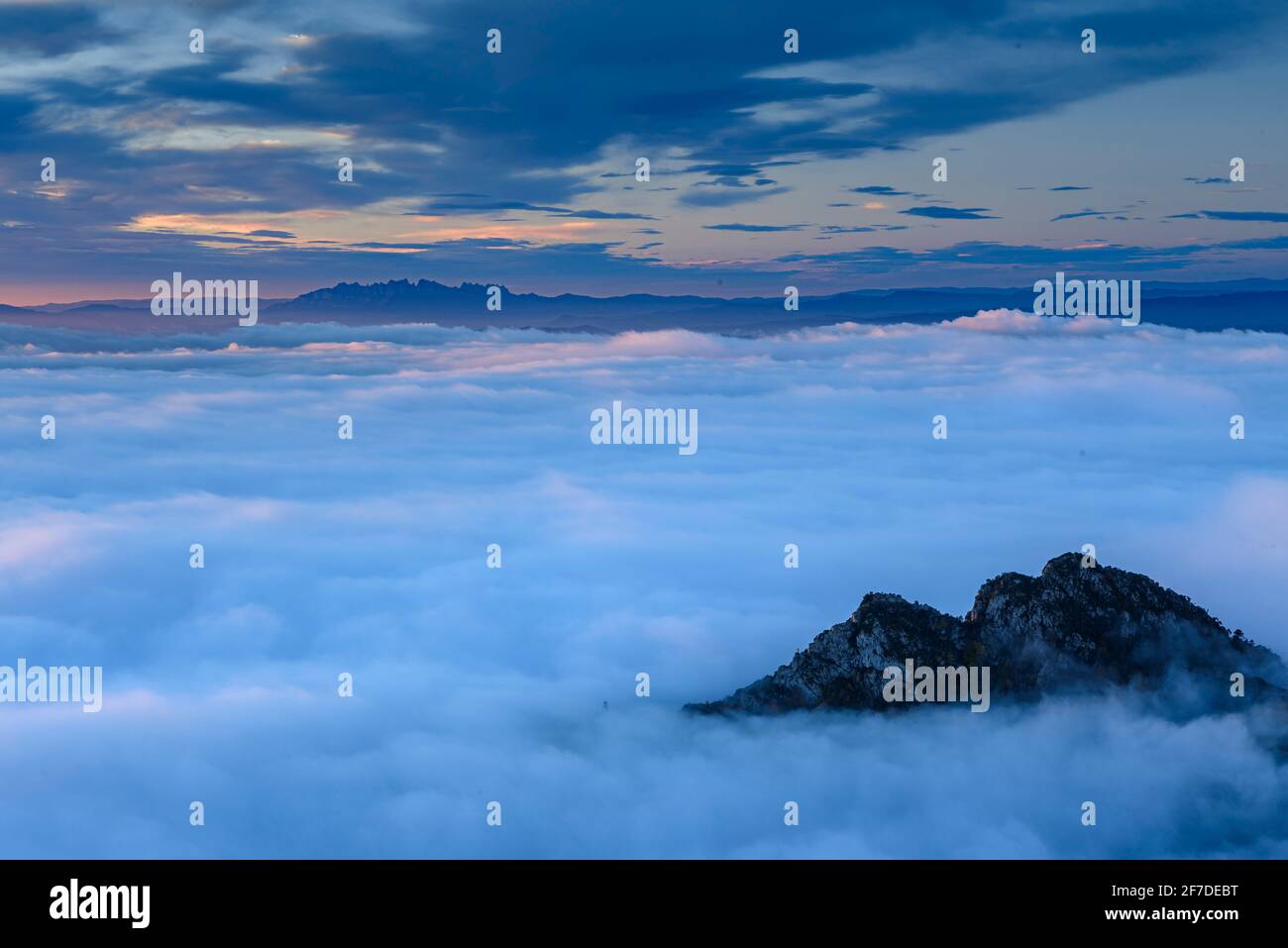Montserrat mountain in a winter sunrise over a sea of clouds seen from the Figuerassa viewpoint, (Berguedà, Catalonia, Spain, Pyrenees) Stock Photo