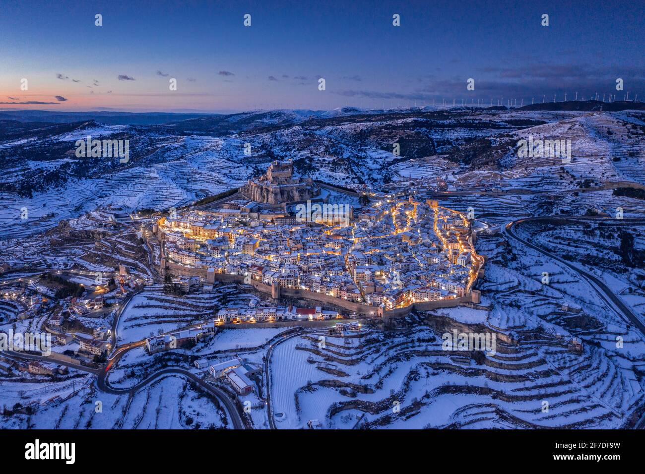 Morella medieval city aerial view, in a winter blue hour, after a snowfall (Castellón, Valencian Community, Spain) ESP: Vista aérea de Morella nevada Stock Photo