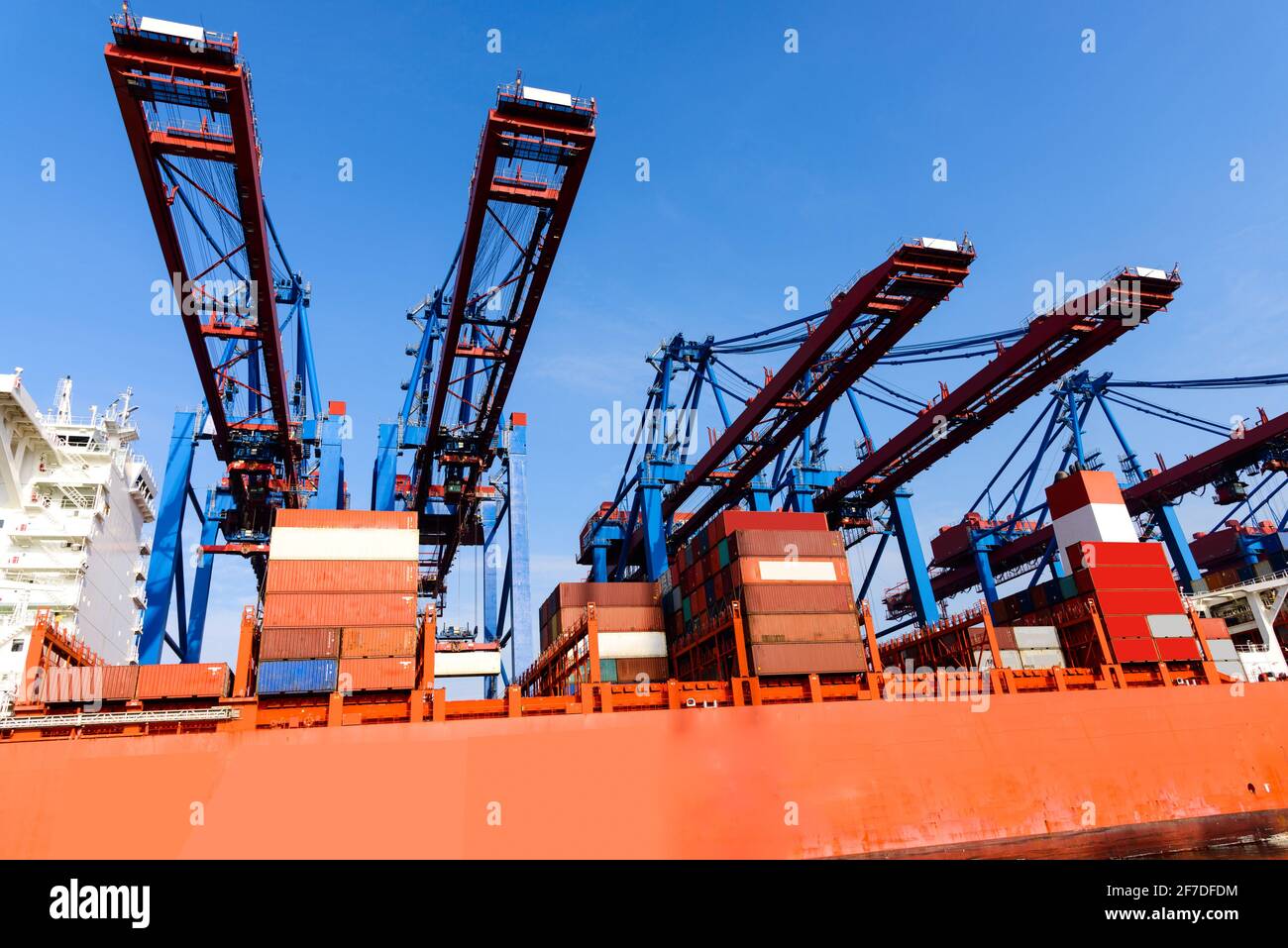 Container terminal gantry cranes for loading and offloading intermodal containers from container cargo ships. Stock Photo