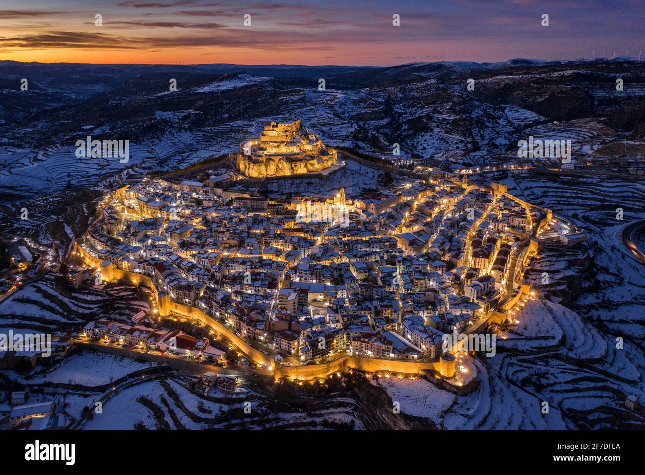 Morella medieval city aerial view, in a winter twilight - blue hour, after a snowfall (Castellón province, Valencian Community, Spain) Stock Photo