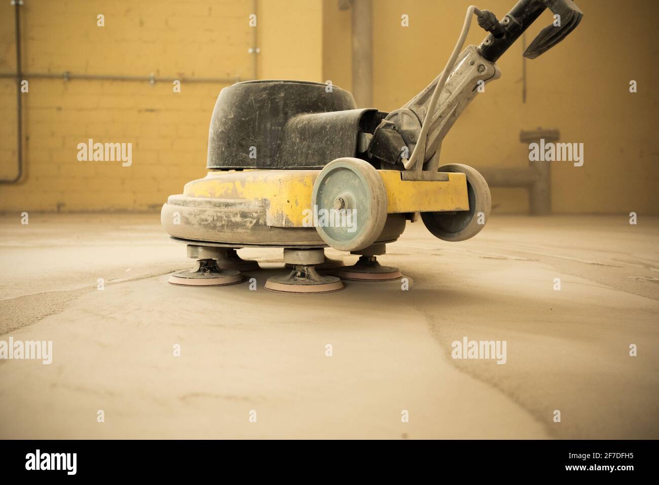 Concrete floor grinding. Construction process. Sanding a concrete floor
