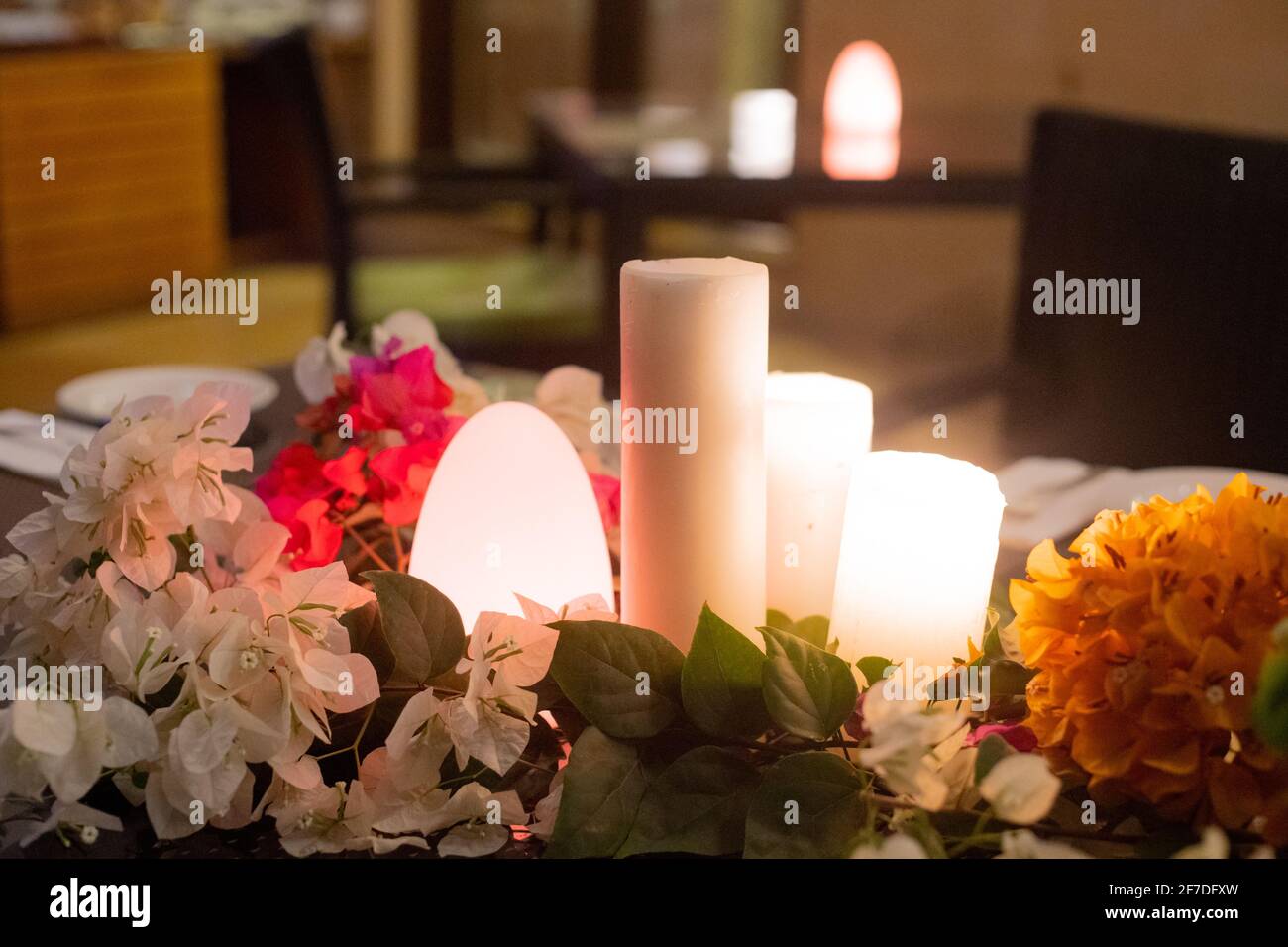 slow wide angle shot with flowers and candles and a flickering dome
