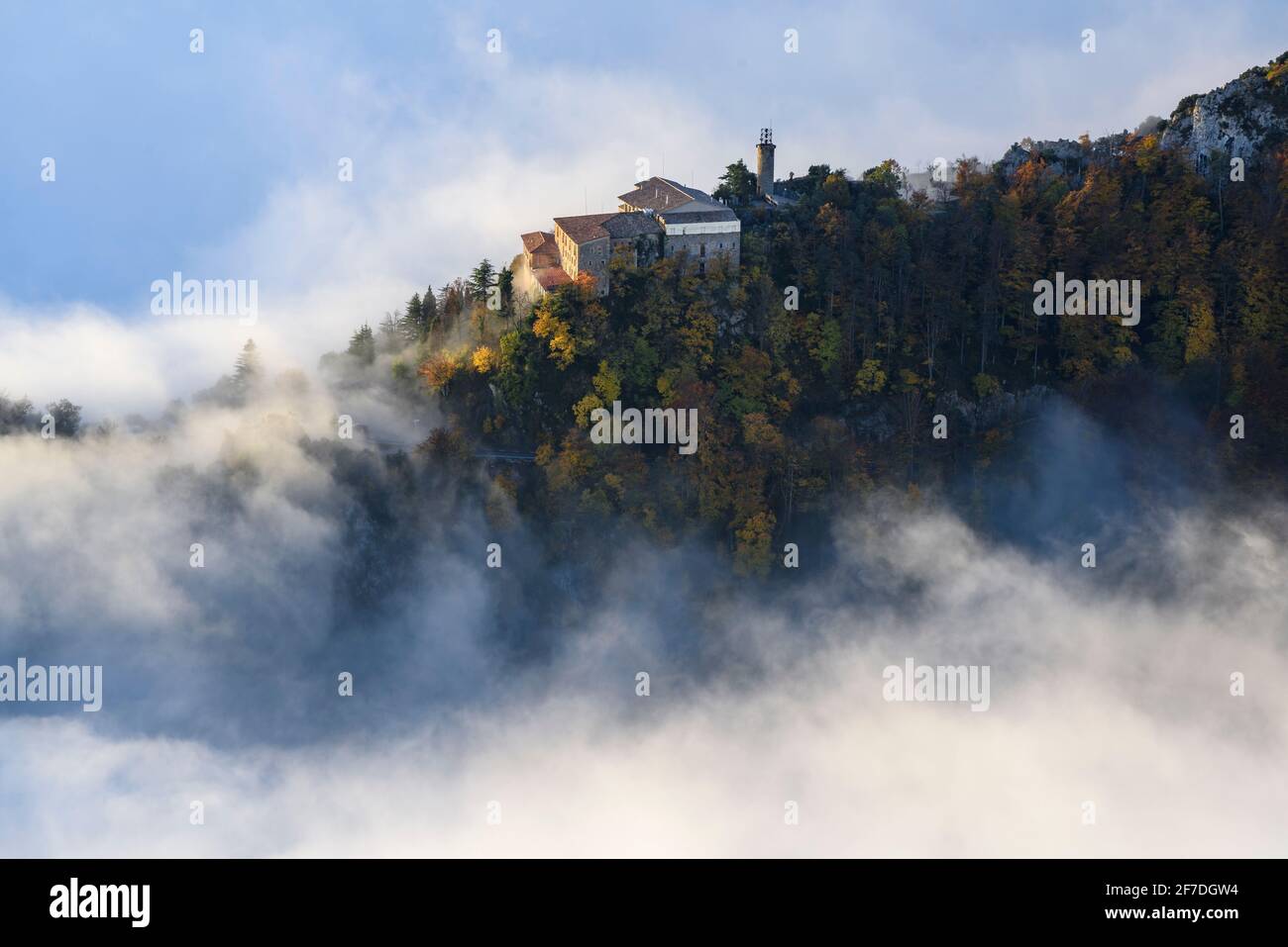Queralt Sanctuary in a winter sunrise over a sea of clouds seen from the Figuerassa viewpoint, (Berguedà, Catalonia, Spain, Pyrenees) Stock Photo