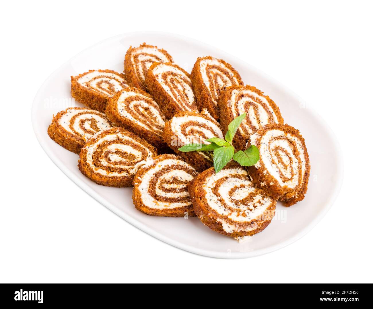 Delicious swiss roll with cream cheese and poppy seeds. Isolated on a white background Stock