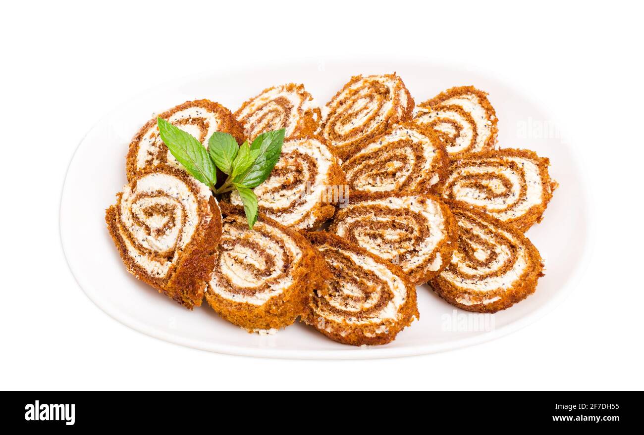 Delicious swiss roll with cream cheese and poppy seeds. Isolated on a white background Stock