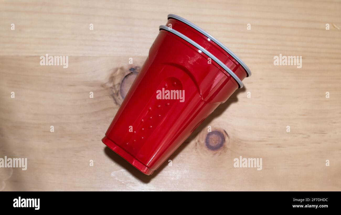 Stacked red party cups on a smooth hardwood countertop, Toronto, Ontario, Canada. Stock Photo