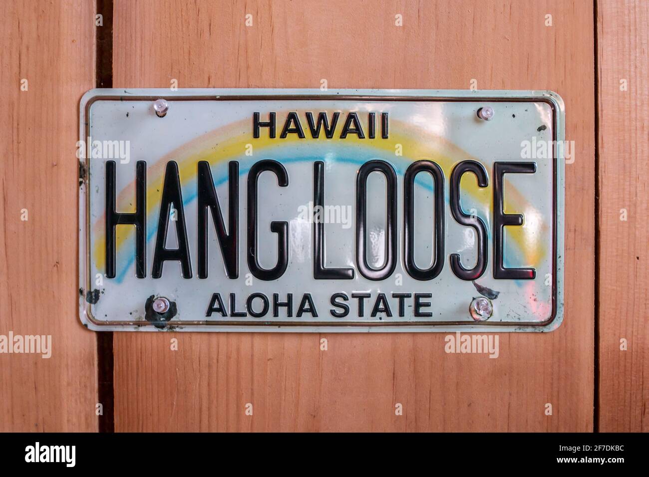 Hang Loose Hawaii Aloha State License Plate tacked up against a cedar wall, Ontario, Canada. Stock Photo